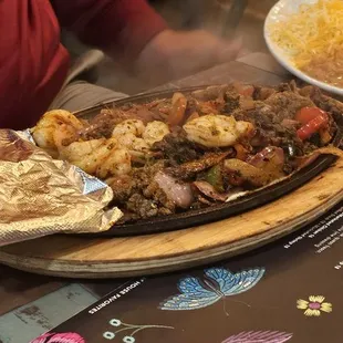 FAJITAS Sautéed peppers &amp; onions, served with rice, borracho beans, sour cream, pico, crisp lettuce, cheese, flour tortillas