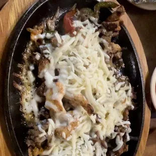 Mixed fajitas chicken and steak with cheese on top! Amazing