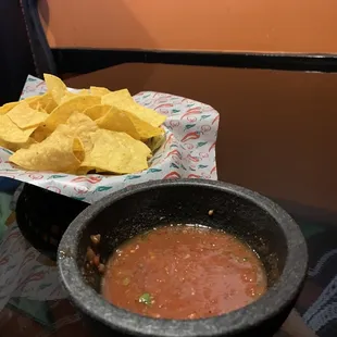 a bowl of salsa and chips