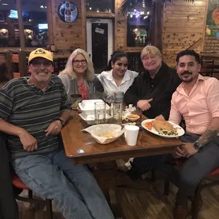 a group of people sitting at a table