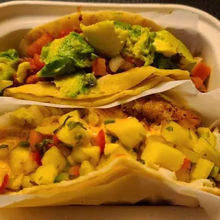 two tacos in a styrofoam container