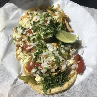 Two chicken fajita tacos with corn tortillas, full of goody and such large portions!