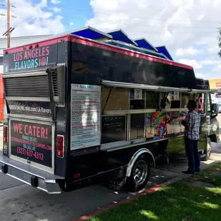 a food truck parked on the side of the road
