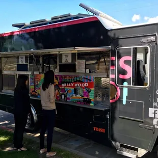 two people ordering food from a food truck