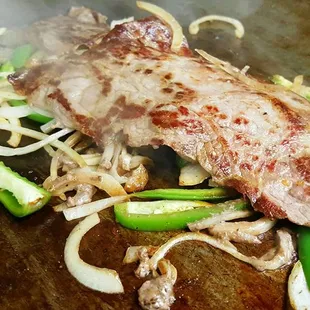Nice looking steak . Grill onions with jalapeño (jalapeño by request only) -Encebollado-