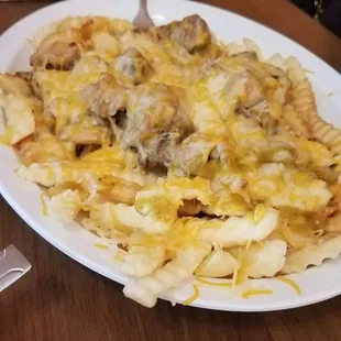 Pork and cheese fries w green sauce on the side (Chile Verde fries). Not on the menu. Bomb