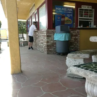 a man standing in front of a restaurant