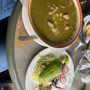 a bowl of soup and a plate of salad