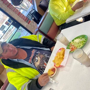 a man sitting at a table in a fast food restaurant