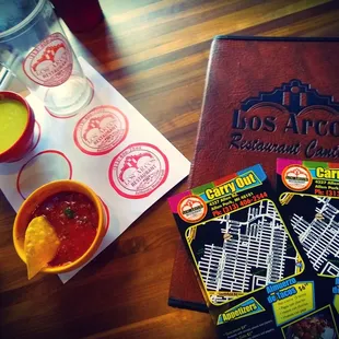 a menu and a bowl of salsa