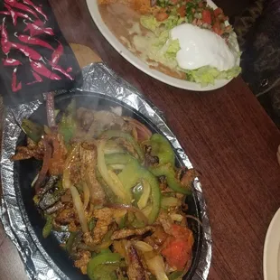 fajitas dish and plate of toppings!
