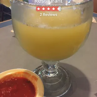 a margarita and a bowl of salsa