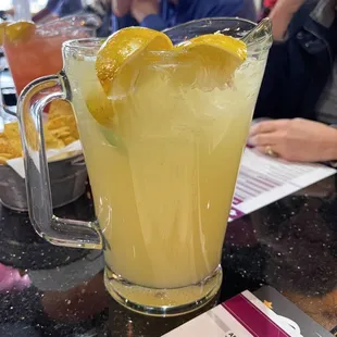 a pitcher of lemonade on a table