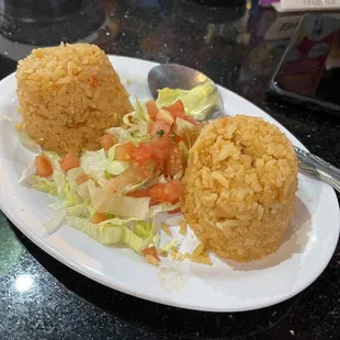 a plate of fried rice and salad