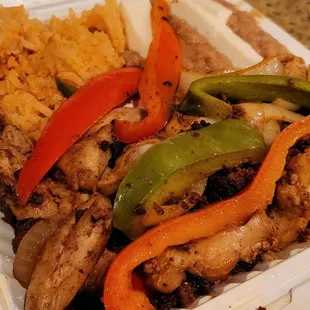 chicken, peppers, and rice in a styrofoam container