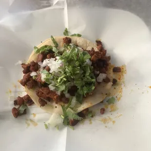 Al pastor taco with powder covering the meat