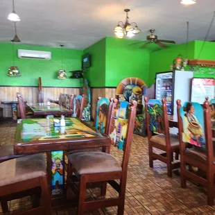 a brightly colored restaurant with tables and chairs