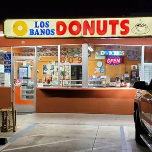a truck parked in front of a donut shop