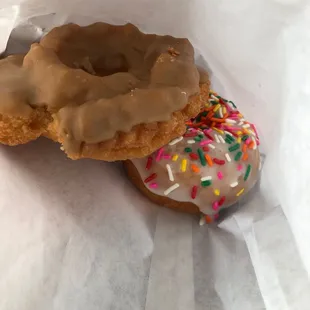 two doughnuts with frosting and sprinkles