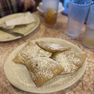 Homemade Sopapillas - SO GOOD. Served with powdered sugar, cinnamon, and honey. Four to an order.