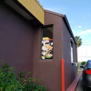 a picture of a restaurant with a menu in the window