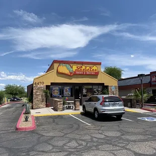 a car parked in front of a restaurant