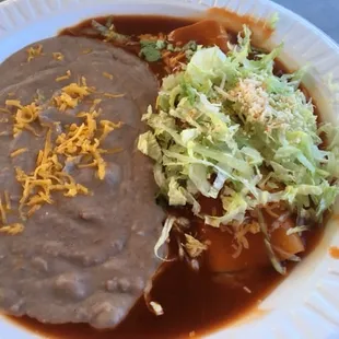 Bean enchilada (available upon request) with a side of beans.