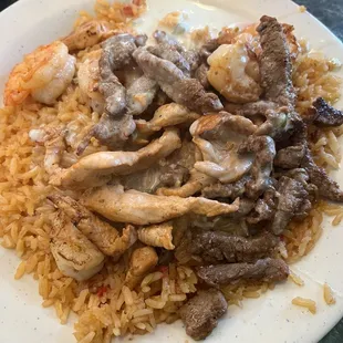 Chicken, Steak and shrimp over rice and cheese