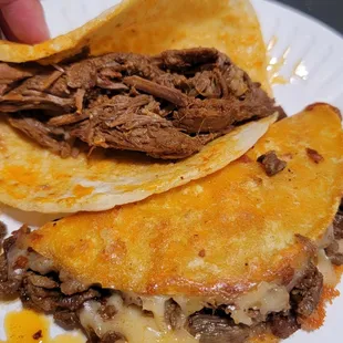 a hand grabbing a tortilla