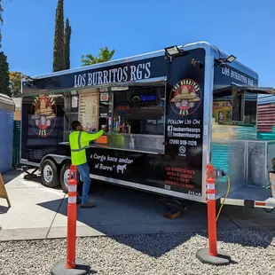 a man standing in front of a food truck