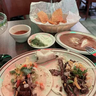 carne asada (steak) tacos, refried beans, chips and salsa, and margarita especial.