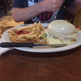 Hamburger covered with cheese.