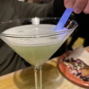 a person stirring up a drink