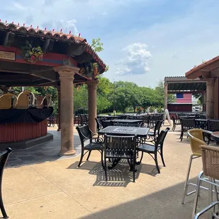 a patio with tables and chairs