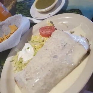 Side of Tomatillo Sauce and the new pastor supremo burrito