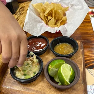 chips and salsa assortments . bottom left is a ceviche dip