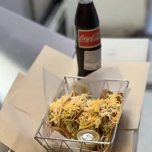 a bottle of coke and a basket of food