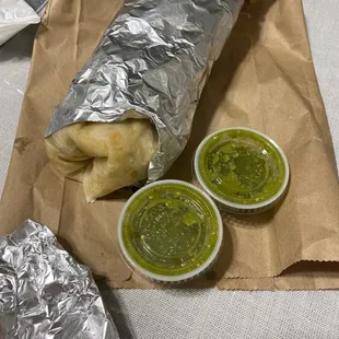 A carnitas super burrito. A pretty hefty boy! And all orders come with sides of salsa