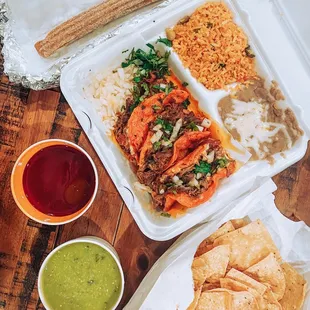 Birria quesadilla dinner, churro, and an appetizer of chips and green tomatillo salsa!
