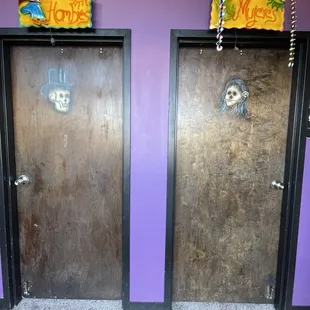 two doors with graffiti on them