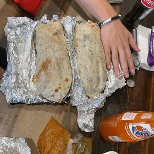 two burritos on aluminum foil