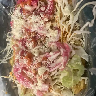 Delicious tajadas (sliced fried plantains) with coleslaw and cheese