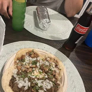 Carne asada and chicken tacos and pastor super burrito.