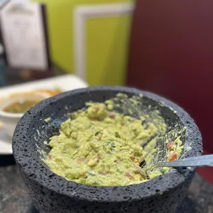 Table side, homemade guacamole! Very tasty!