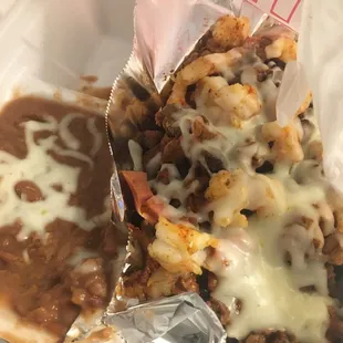 Discada with shrimp, beef and hot dogs. Came with refried beans. Was supposed to have tortillas but he forgot them..