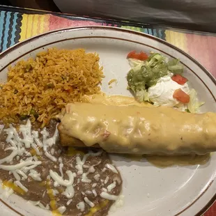 Shredded Chicken Chimichanga topped with Queso Rice and Beans and toppings