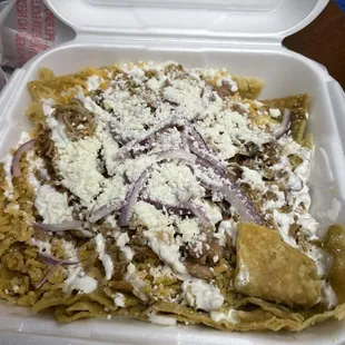 Delicious carnitas chilaquiles with habanero sauce, rice &amp; beans!