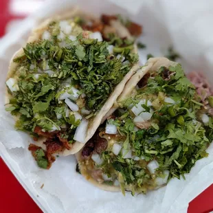 Crispy chicharron taco on the left and carnitas taco on the right.
