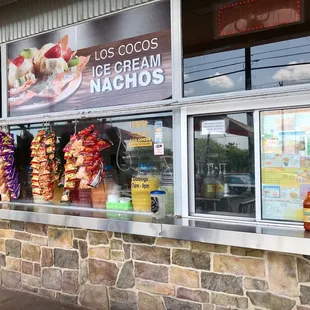 First order window with menu and selection of snacks flanking both sides