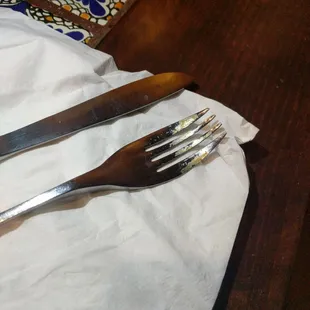Dirty silverware, all crusted to the fork